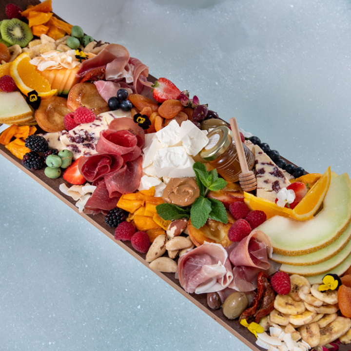 Close up image of a charcuterie board laid across a bathtub
