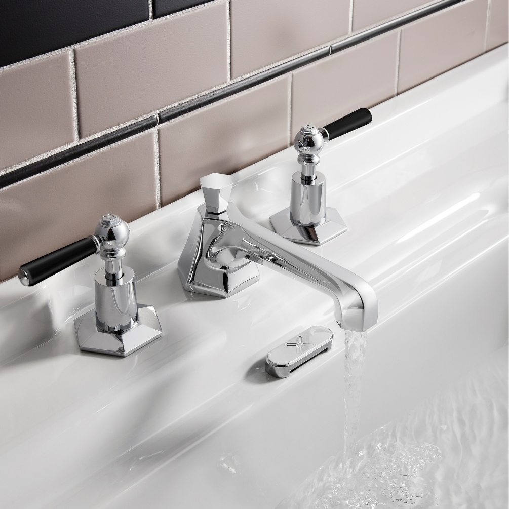 Lifestyle image of the Crosswater Waldorf Chrome 3 Tap Hole Black Lever Handle Deck Mounted Basin Mixer installed on the deck of a basin