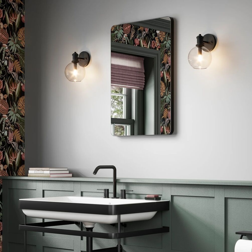 Lifestyle image of the hib. Trim Curve 400mm x 600mm Black Bathroom Mirror mounted above a traditional basin