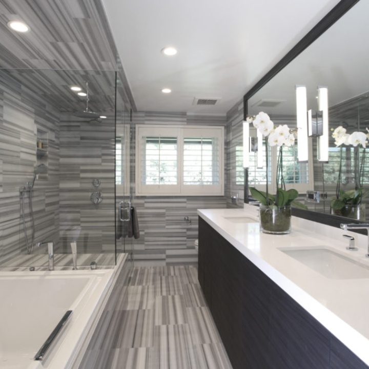 Lifestyle image of a grey bathroom design, featuring grey striped tiles across its floor and walls