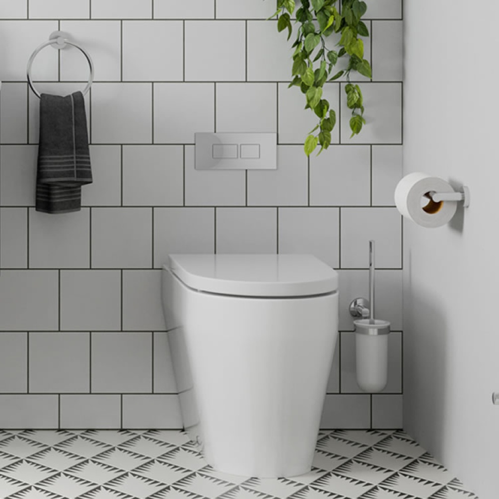 Photo of the Hoxton Toilet Brush Holder with the Hoxton toilet, other chrome accessories and white tiled wall