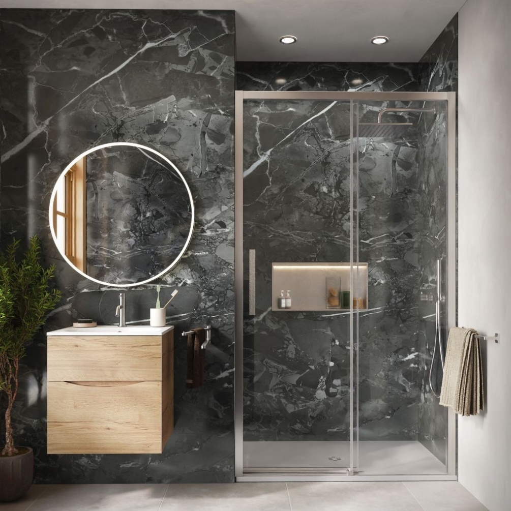 Lifestyle image of the Showerwall Laminate Pandora Marble 2440mm x 879mm Proclick Hydrocore Wall Panel - SW100 installed within a black and gold bathroom with enclosed walk-in shower, round mirror and vanity unity & basin