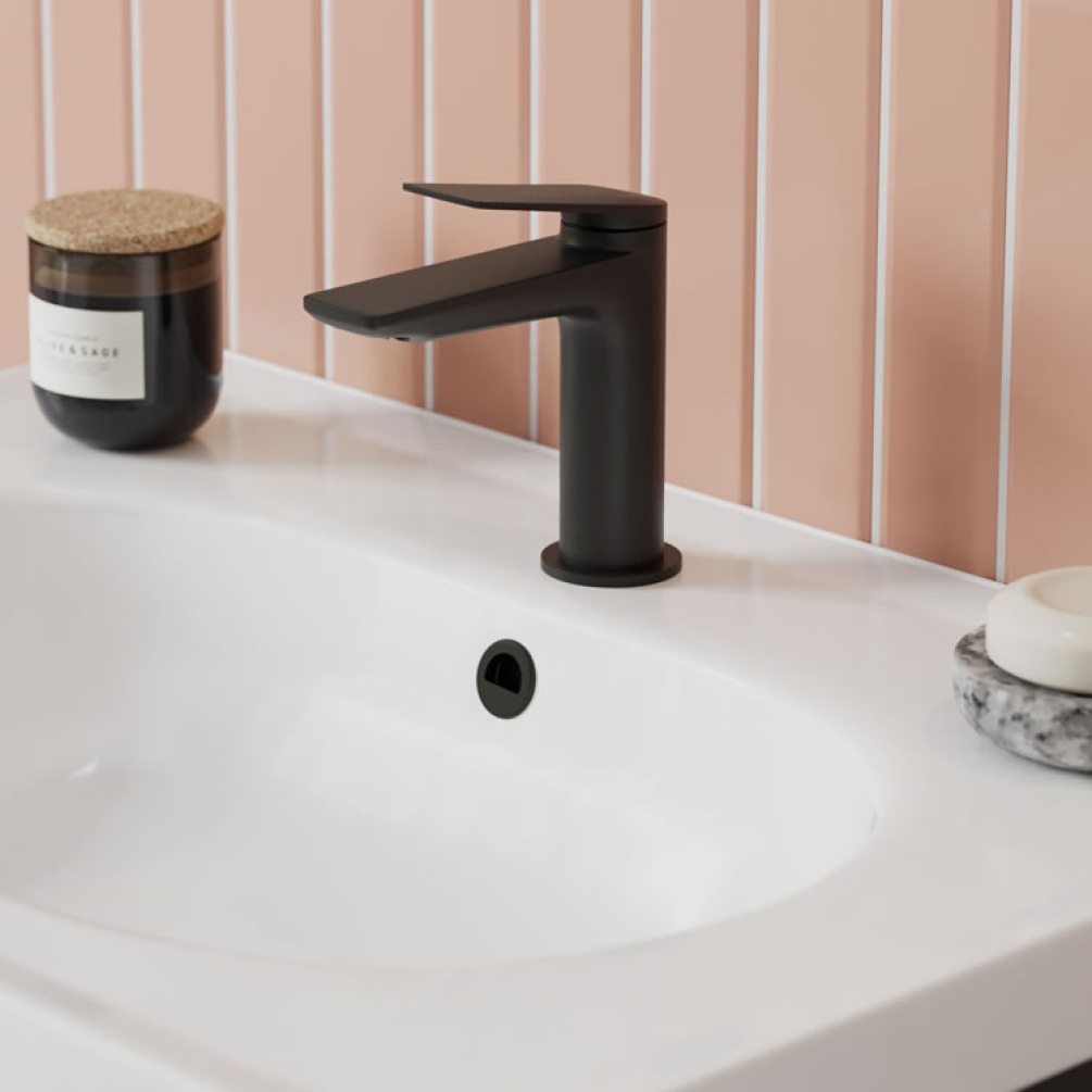 Photo of the Hoxton Overflow Cover in Matt Black with light pink tiles