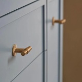 product lifestyle image of Roper Rhodes Untreated Brass Toledo T-Bar Handle on grey unit FHTOLHANA