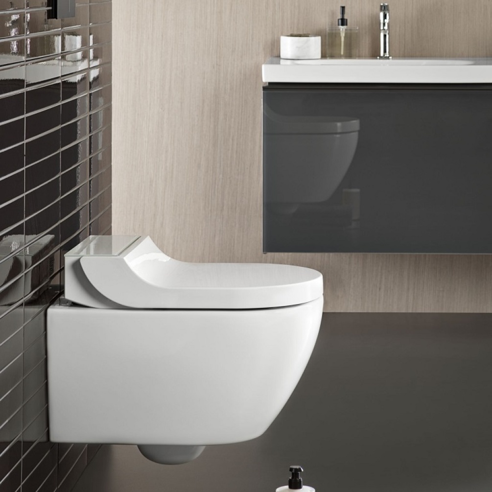 product lifestyle image of Geberit AquaClean Tuma Comfort Wall Hung Smart Bidet Toilet with White Glass Design Cover Side on in metro tiled bathroom - 146.290.SI.1