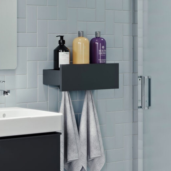 image of an open box bathroom shelf with bottles included and hanging towels underneath