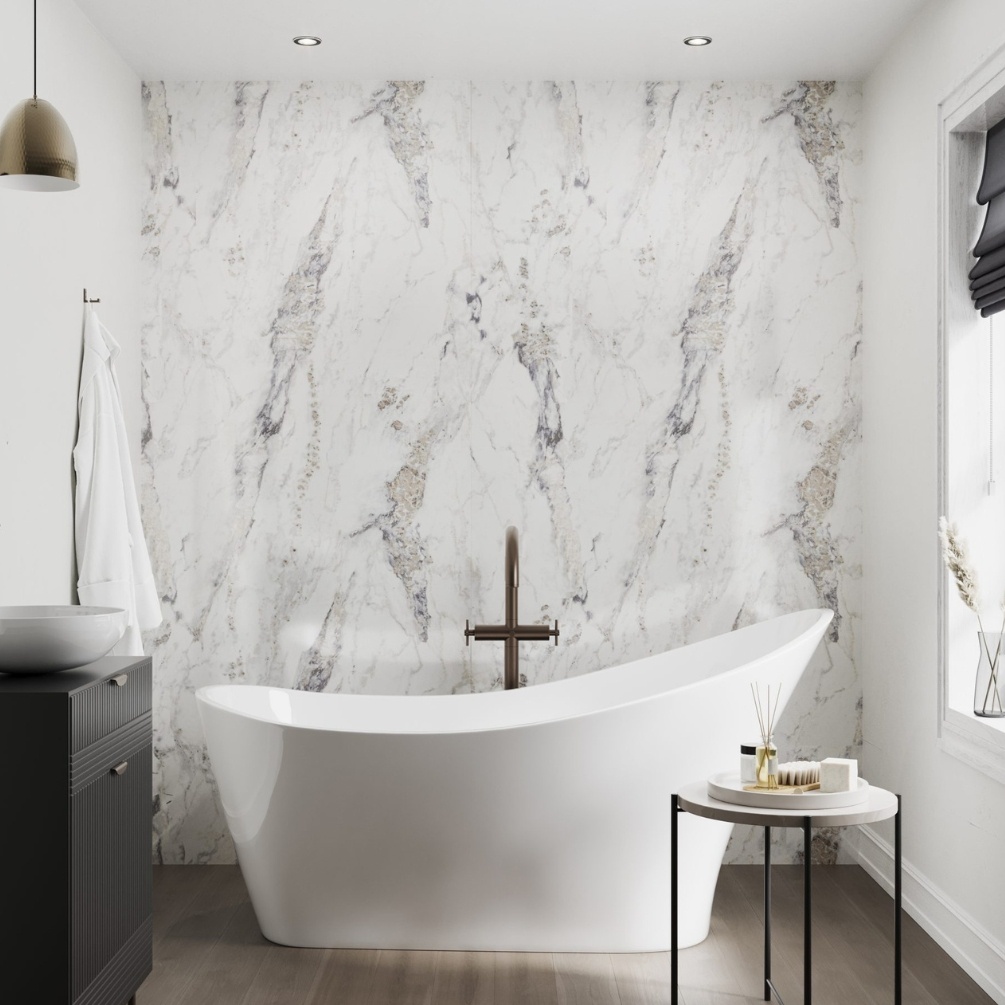 Lifestyle image of the Showerwall Laminate Breccia Marble 2440mm x 900mm Square Cut MDF Wall Panel - SW80 within a bathroom with a centre positioned slipper bath
