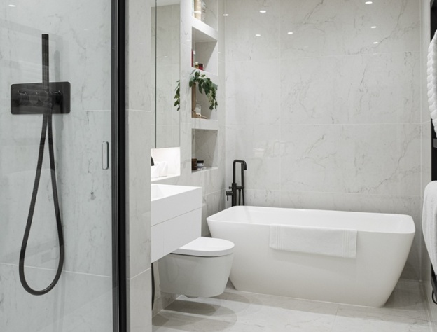 image of a freestanding bath in a white marble bathroom with a black recessed shower door and shower hanset