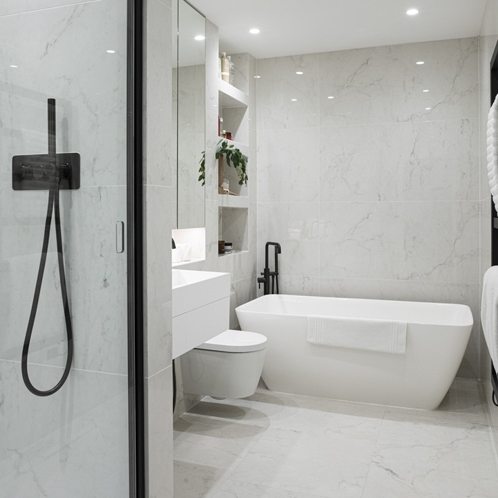 image of a freestanding bath in a white marble bathroom with a black recessed shower door and shower hanset
